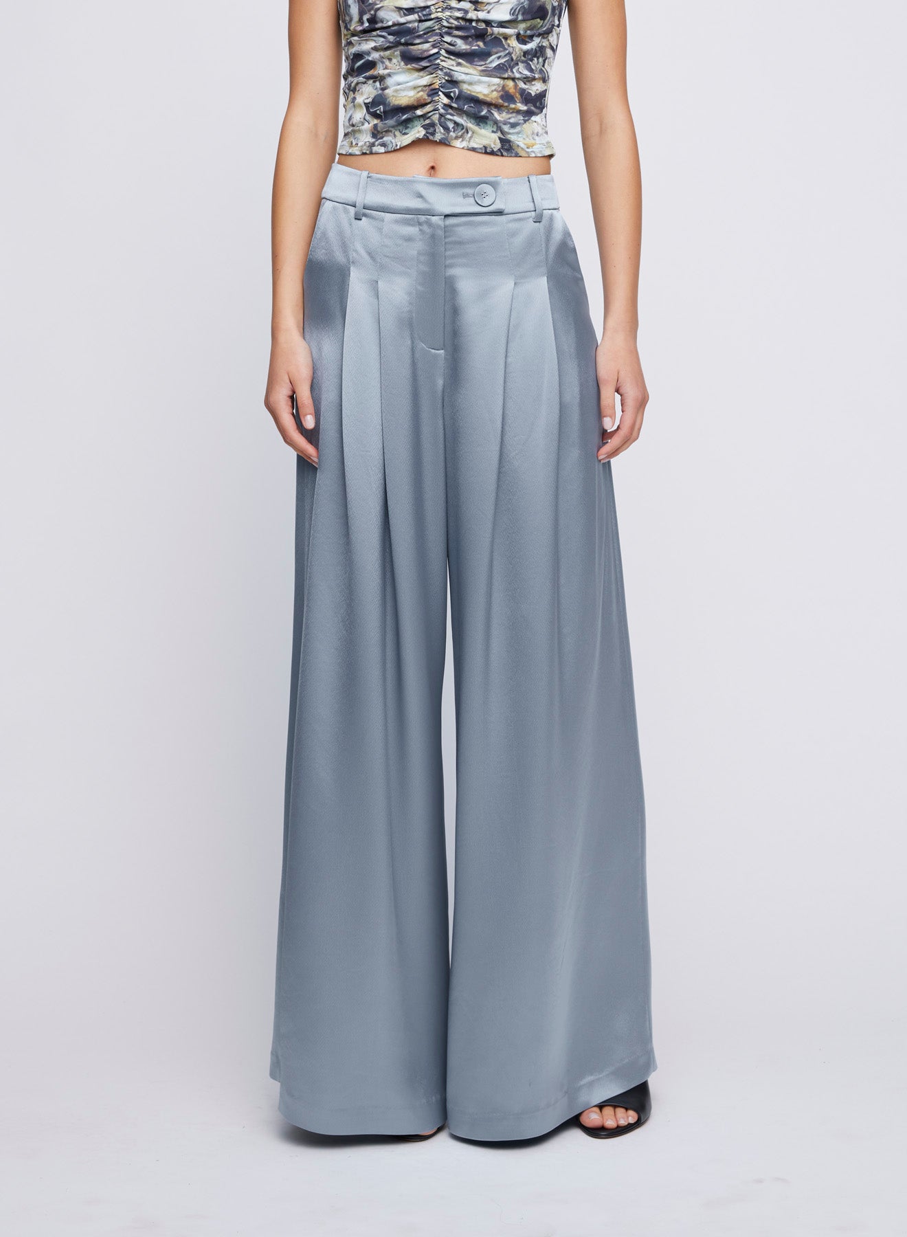 Wide-Leg Steel Satin Dress Pant featuring front pleating. High waist silhouette is constructed with front pleating, cut wide for fluid movement. Elevate your everyday wardrobe with this chic and versatile piece. Try for a day look with a basic top or match with the Mason Shirt for a dinner pant or party look. Dinner pant, event pant, everyday pant, wide-leg pant, dressy wide-leg pants.
